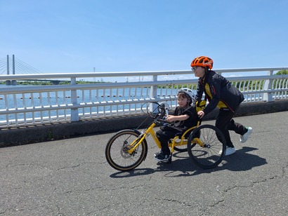 Scene of riding handbikes under clear blue sky