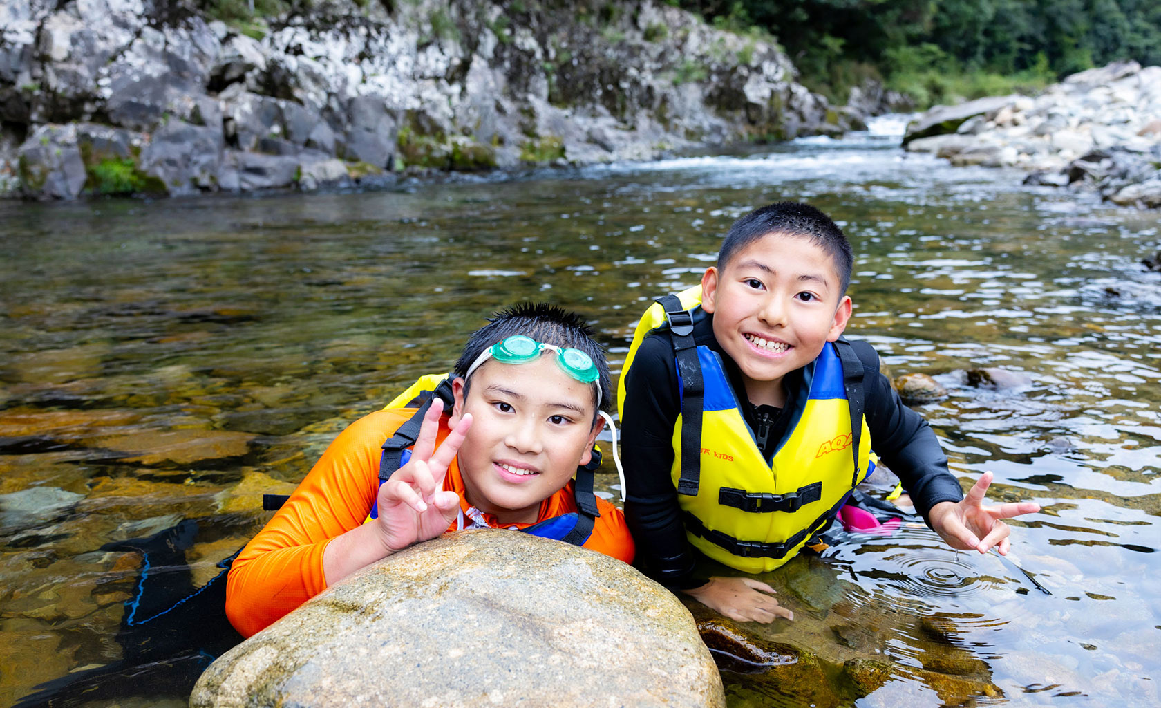 smiling children outdoors on the river
